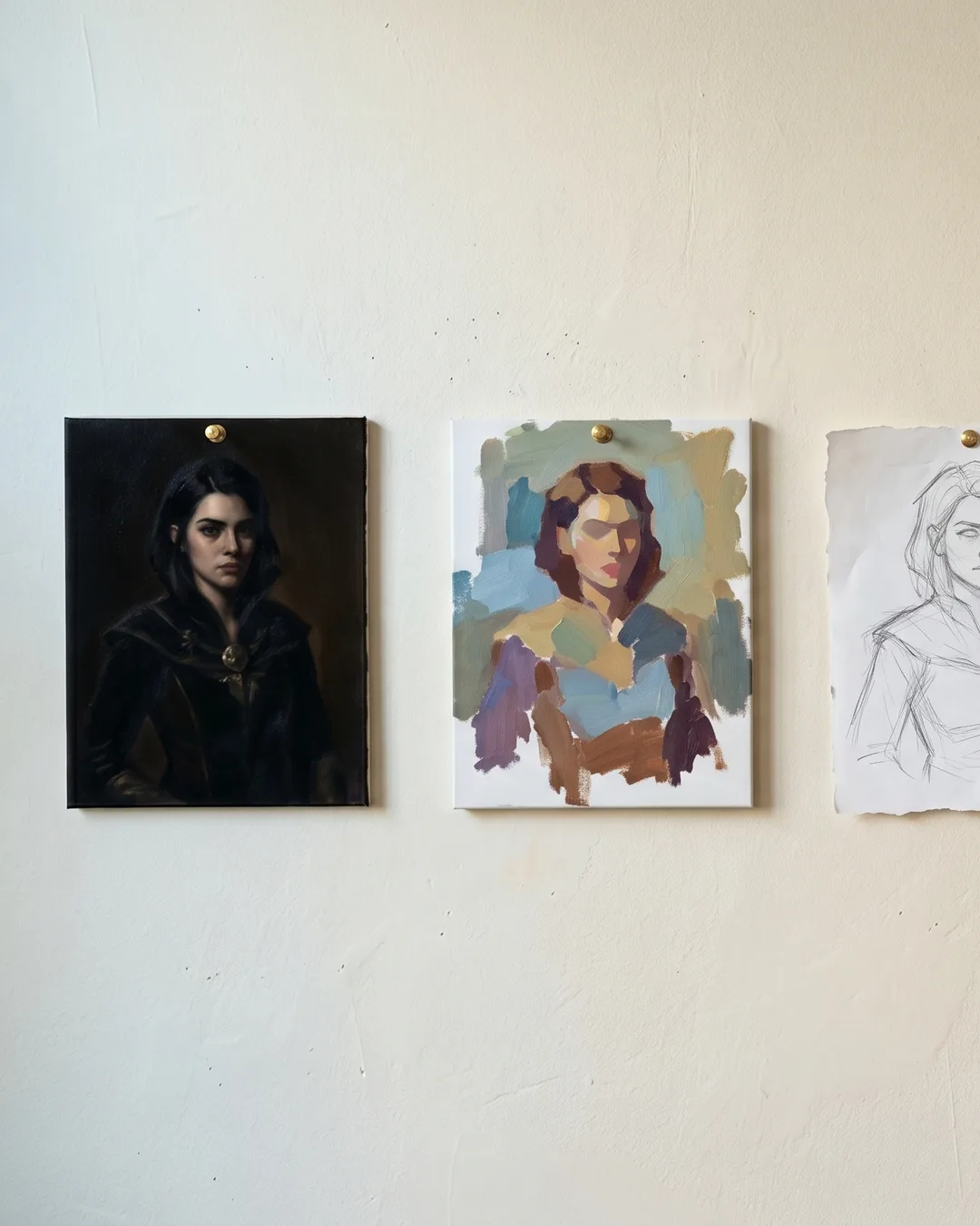 Painter's studio wall with five commissions in progress at different stages