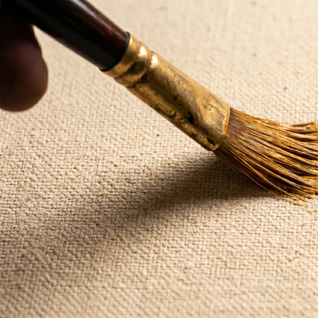 Detail — stylus tip on tablet screen showing a brushstroke